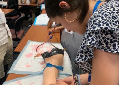 Bailey working on a prosthetic arm at her nursing immersion program.