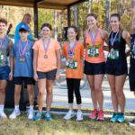 Women's winners at 5k, standing in a row with their medals.