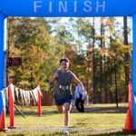 5k 1st place winner running through the finish line.