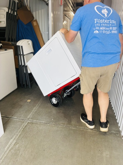 Regional Manager delivering supplies to a family in need of Tangible Needs.