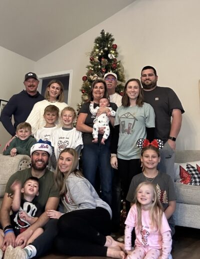Scott's Story: Scott Bowser with this immediate and extended family in front of their Christmas Tree.